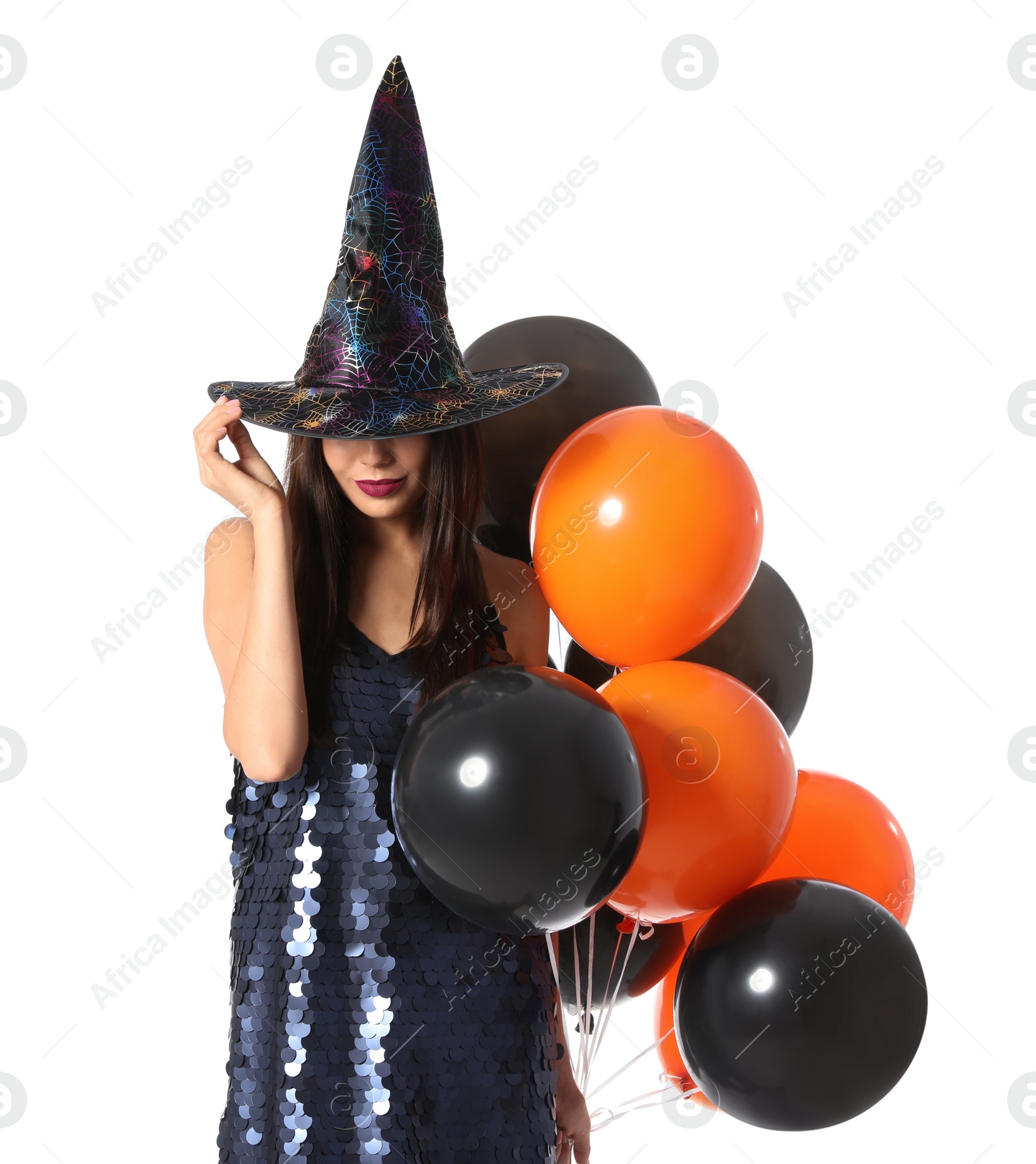 Photo of Beautiful woman wearing witch costume with balloons for Halloween party on white background