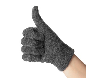 Photo of Woman in grey woolen glove showing thumb up gesture on white background, closeup. Winter clothes