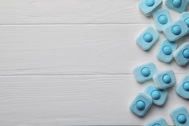 Photo of Water softener tablets on white wooden table, flat lay. Space for text