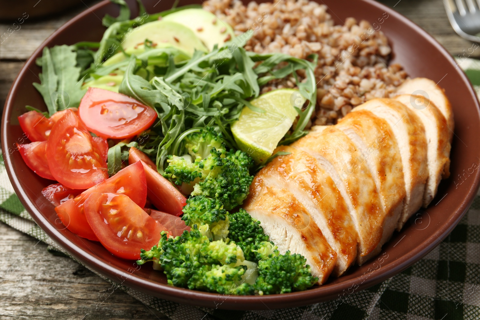 Photo of Healthy meal. Tasty products in bowl on wooden table, closeup