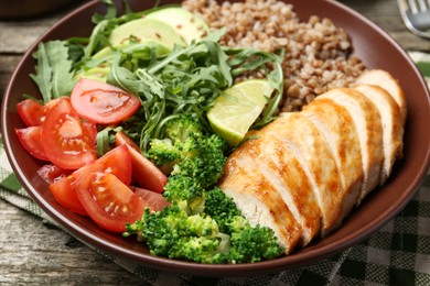 Healthy meal. Tasty products in bowl on wooden table, closeup