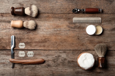 Photo of Flat lay composition with men's shaving accessories and space for text on wooden background