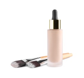 Bottle of skin foundation and brushes on white background. Makeup product