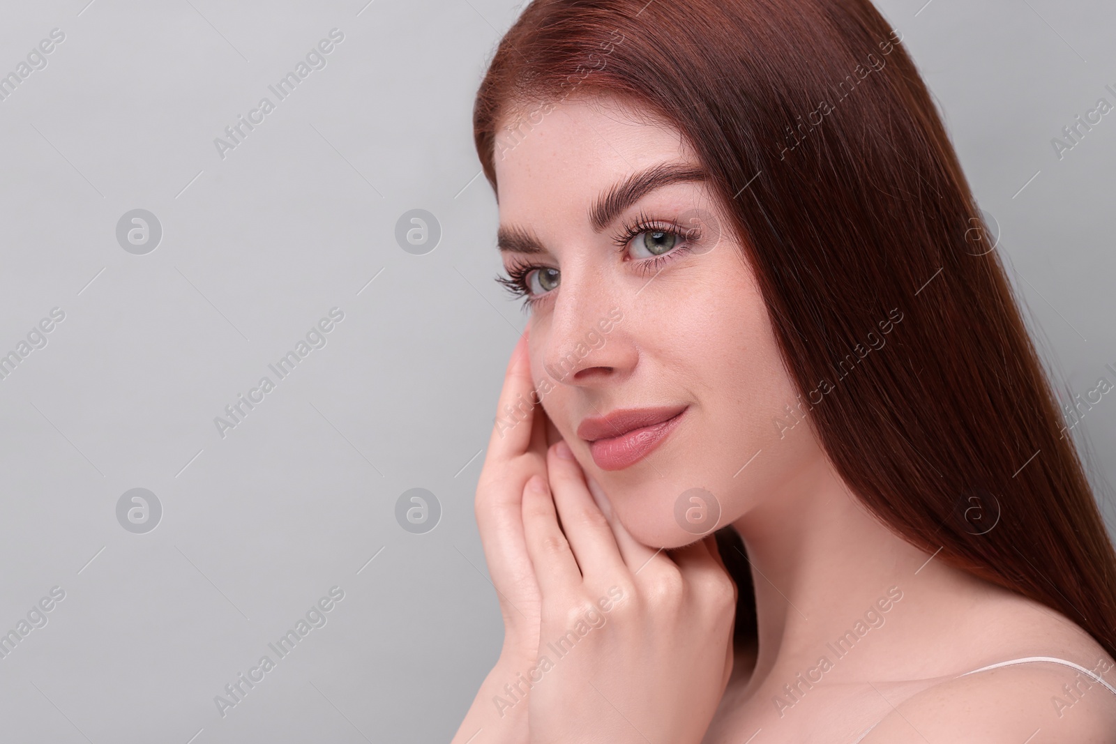 Photo of Portrait of beautiful woman on grey background, closeup. Space for text