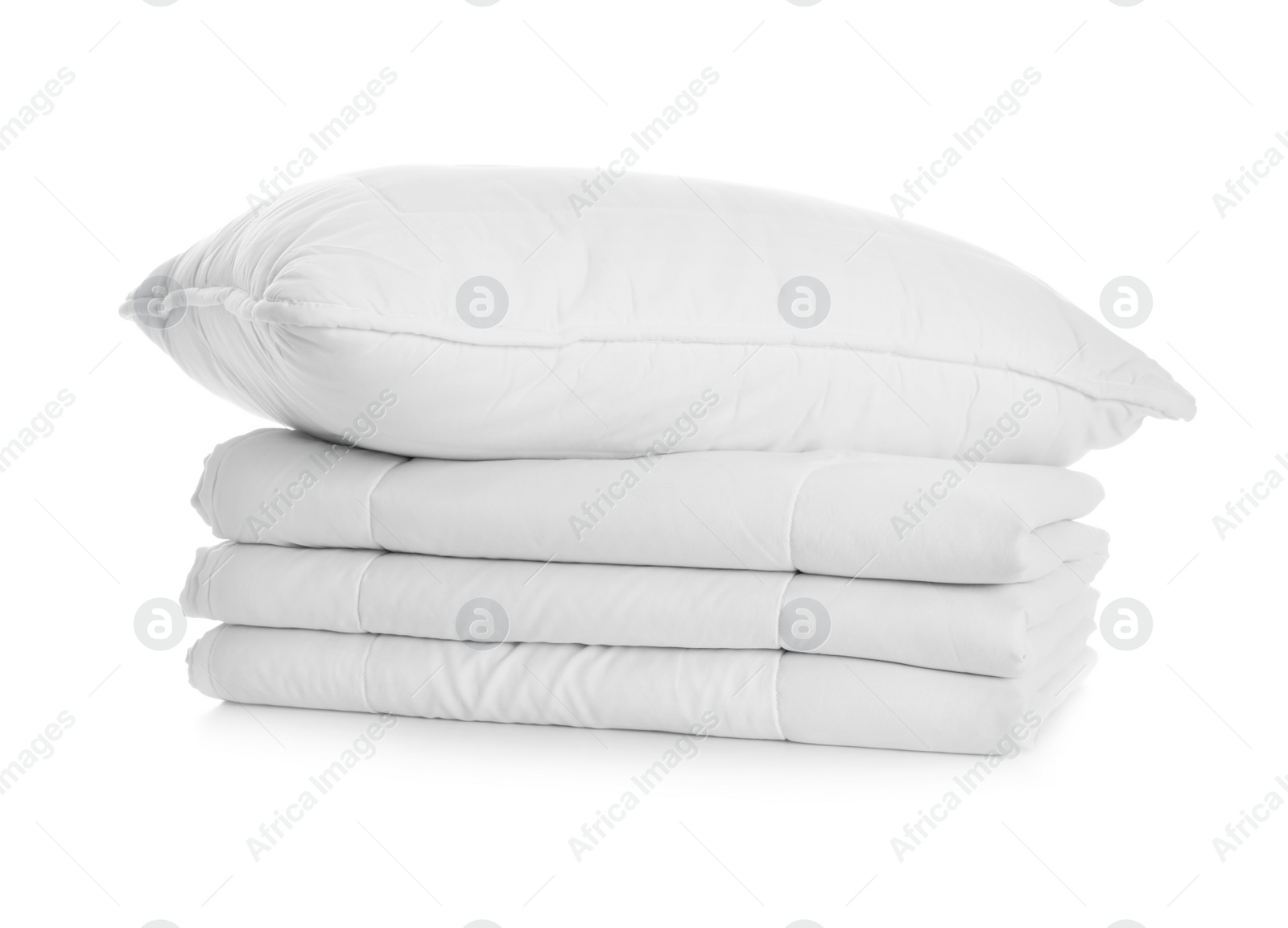 Photo of Folded clean blanket and pillow isolated on white