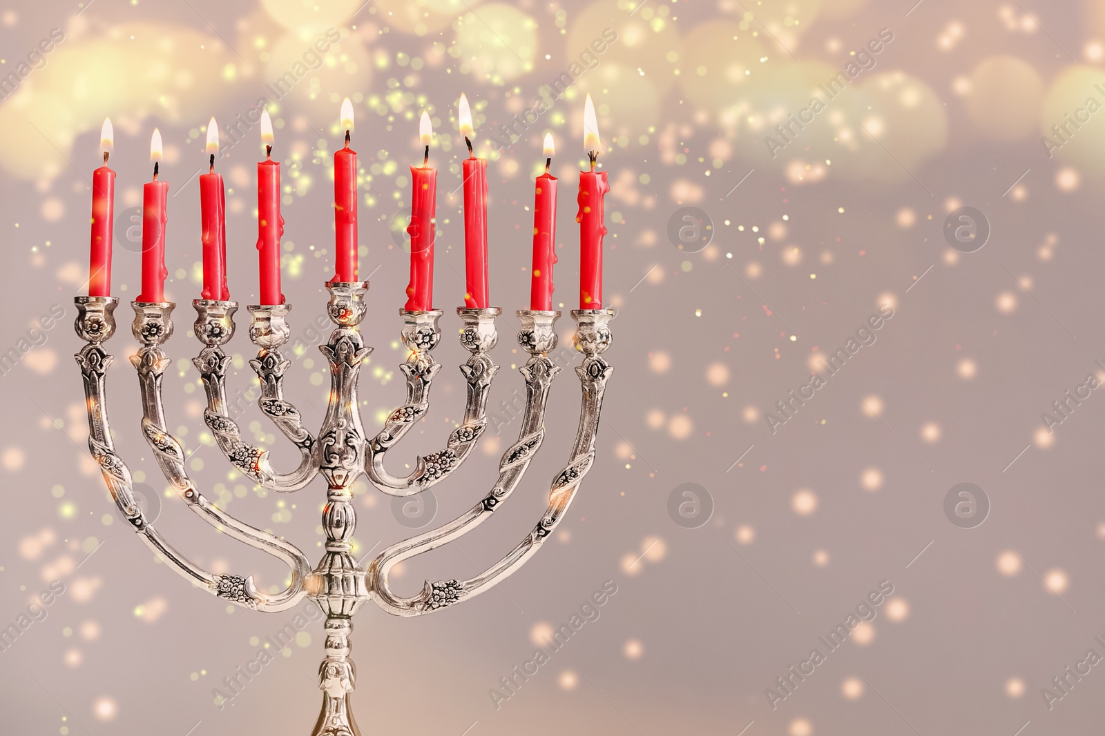 Image of Silver menorah with burning candles on light background, space for text. Hanukkah celebration