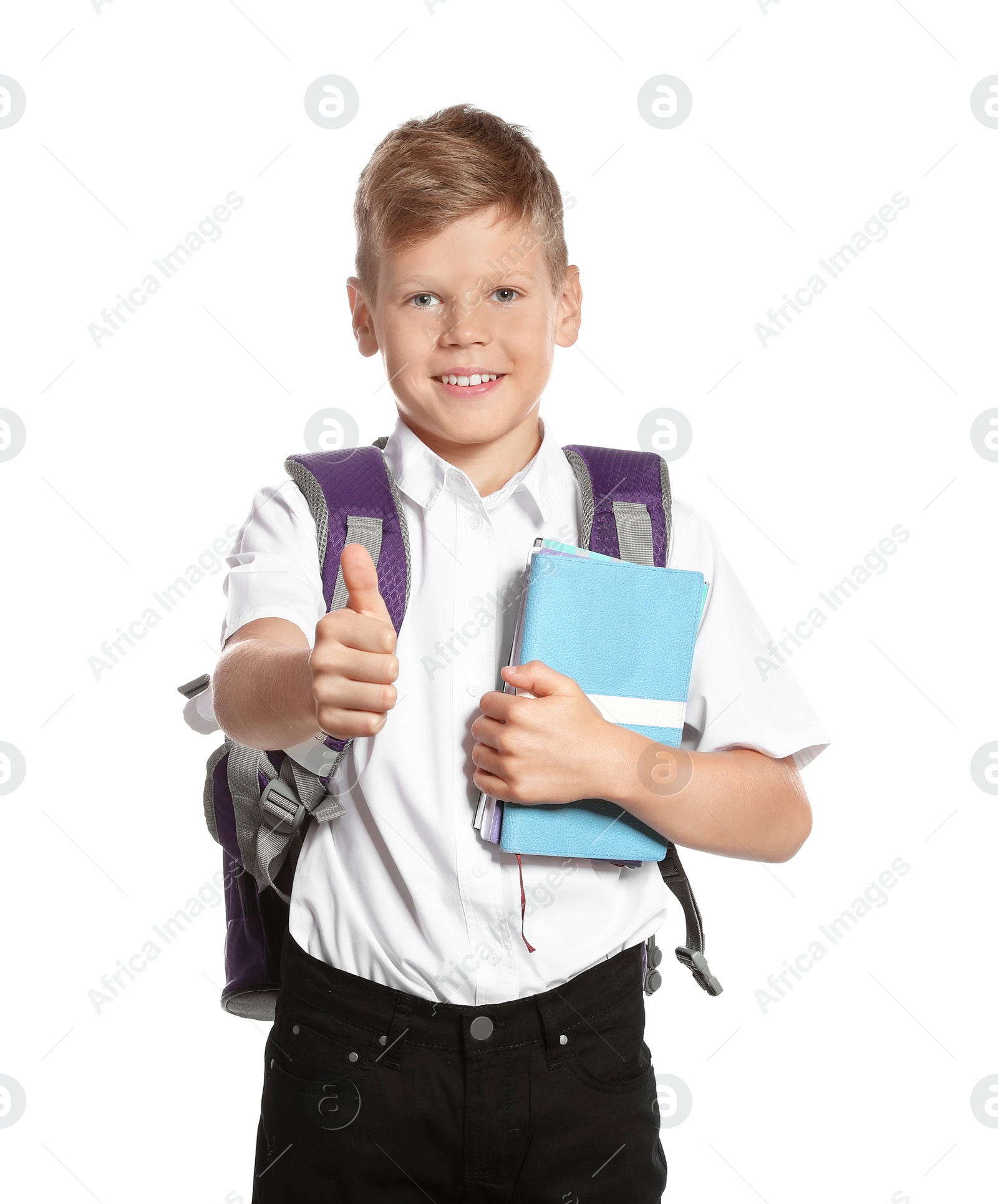 Photo of Cute boy with school stationery showing thumb up on white background