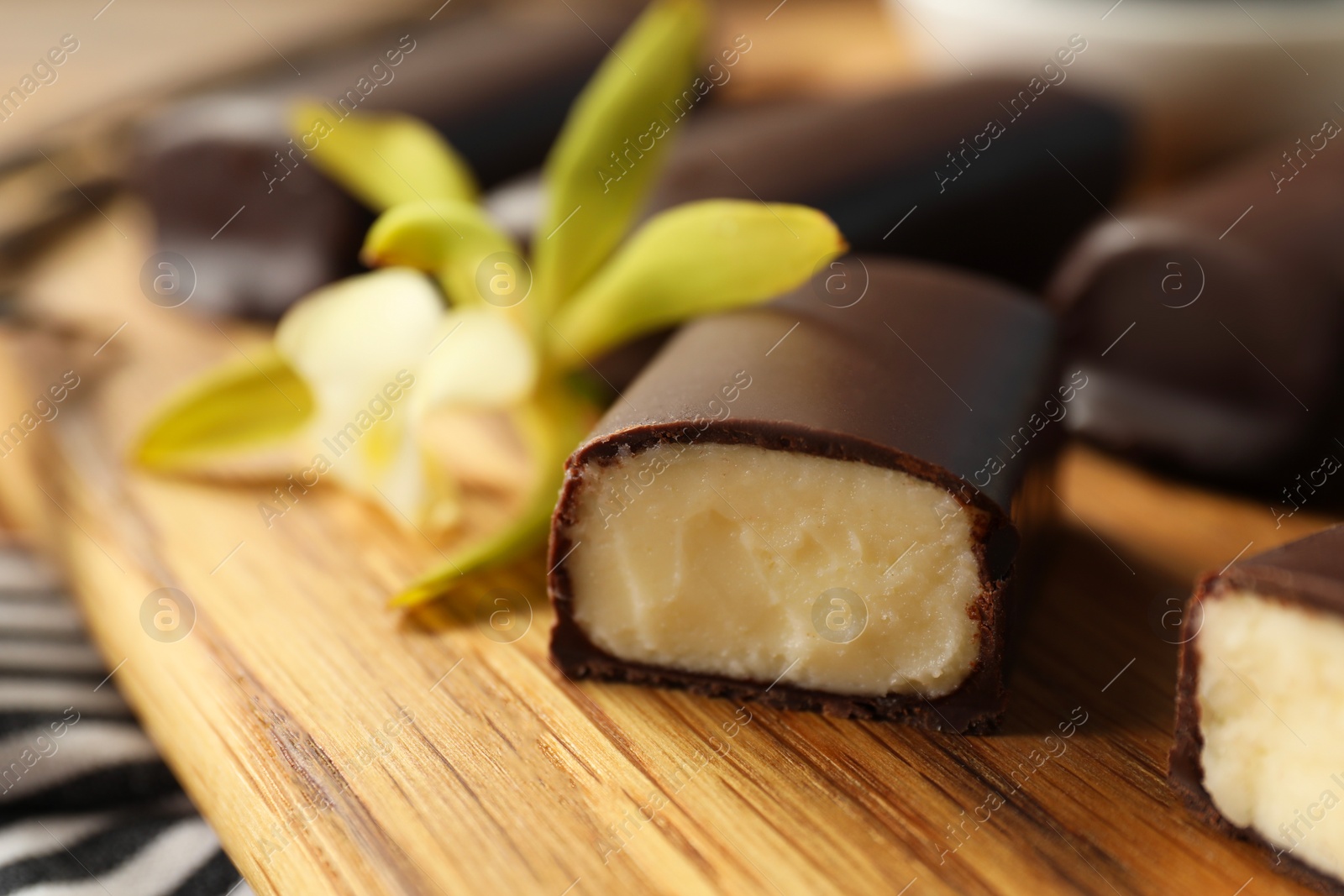 Photo of Glazed vanilla curd cheese bars on table, closeup