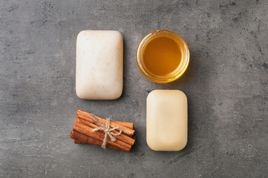 Photo of Flat lay composition with soap bars and ingredients on grey background
