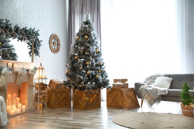 Stylish interior with decorated Christmas tree in living room