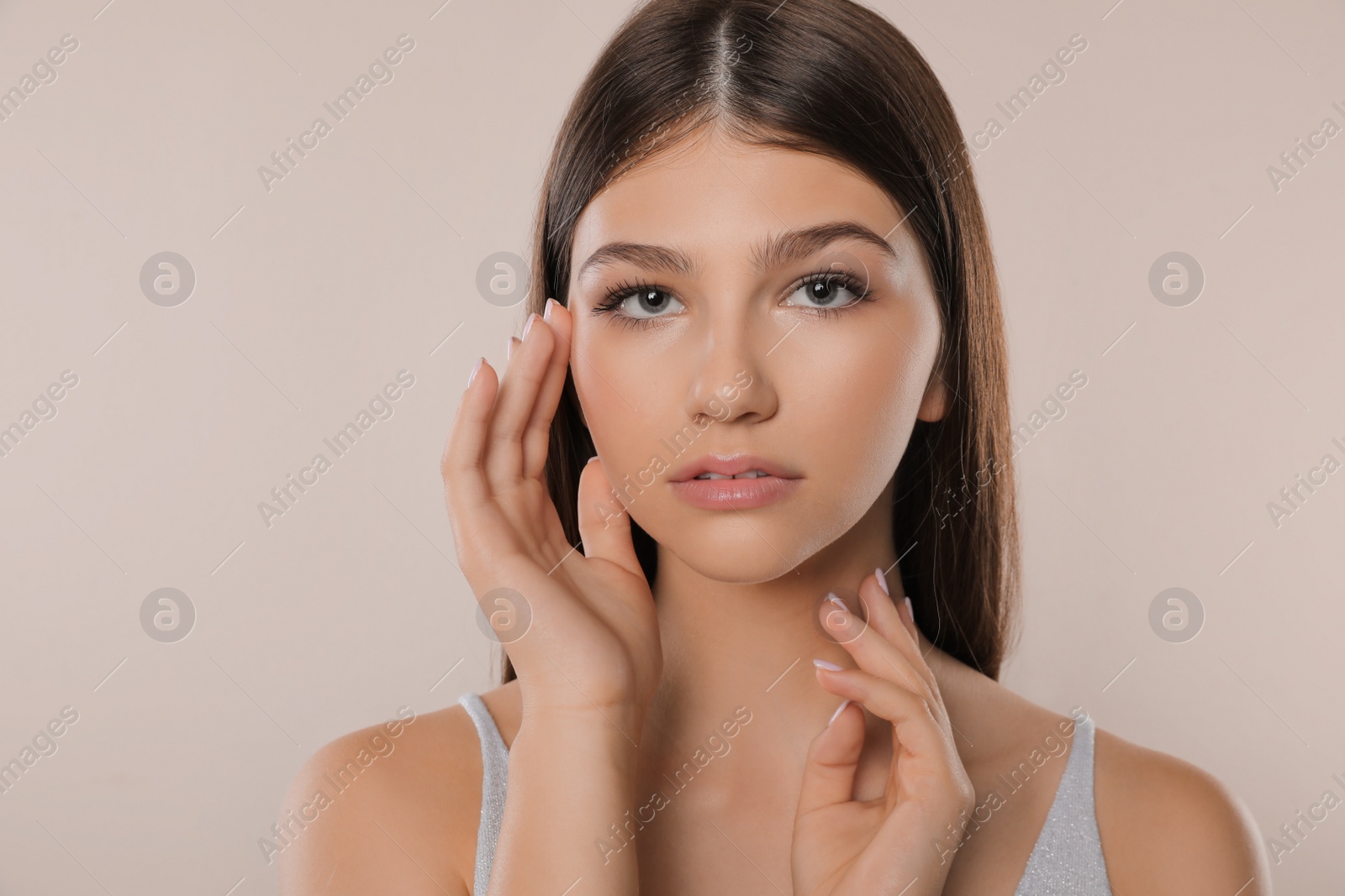 Photo of Portrait of pretty girl on light background. Beautiful face with perfect smooth skin