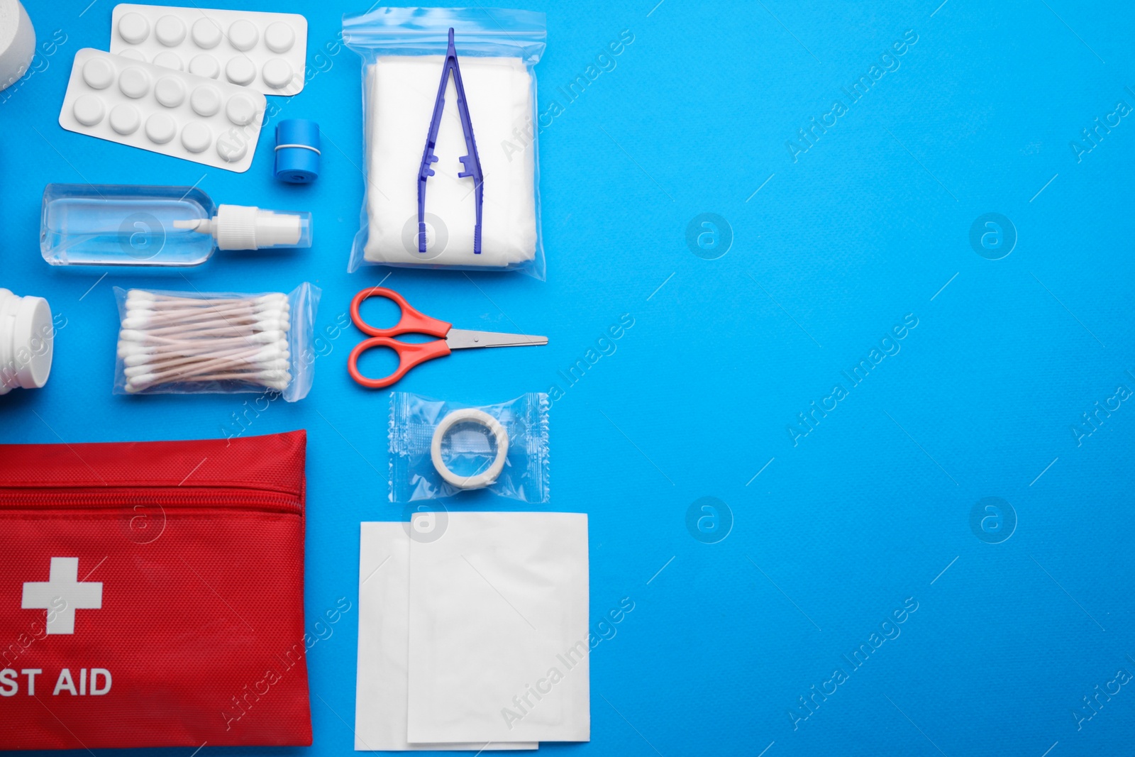 Photo of Flat lay composition with first aid kit on light blue background. Space for text