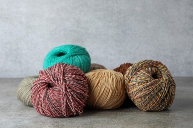 Photo of Many different soft woolen yarns on grey table