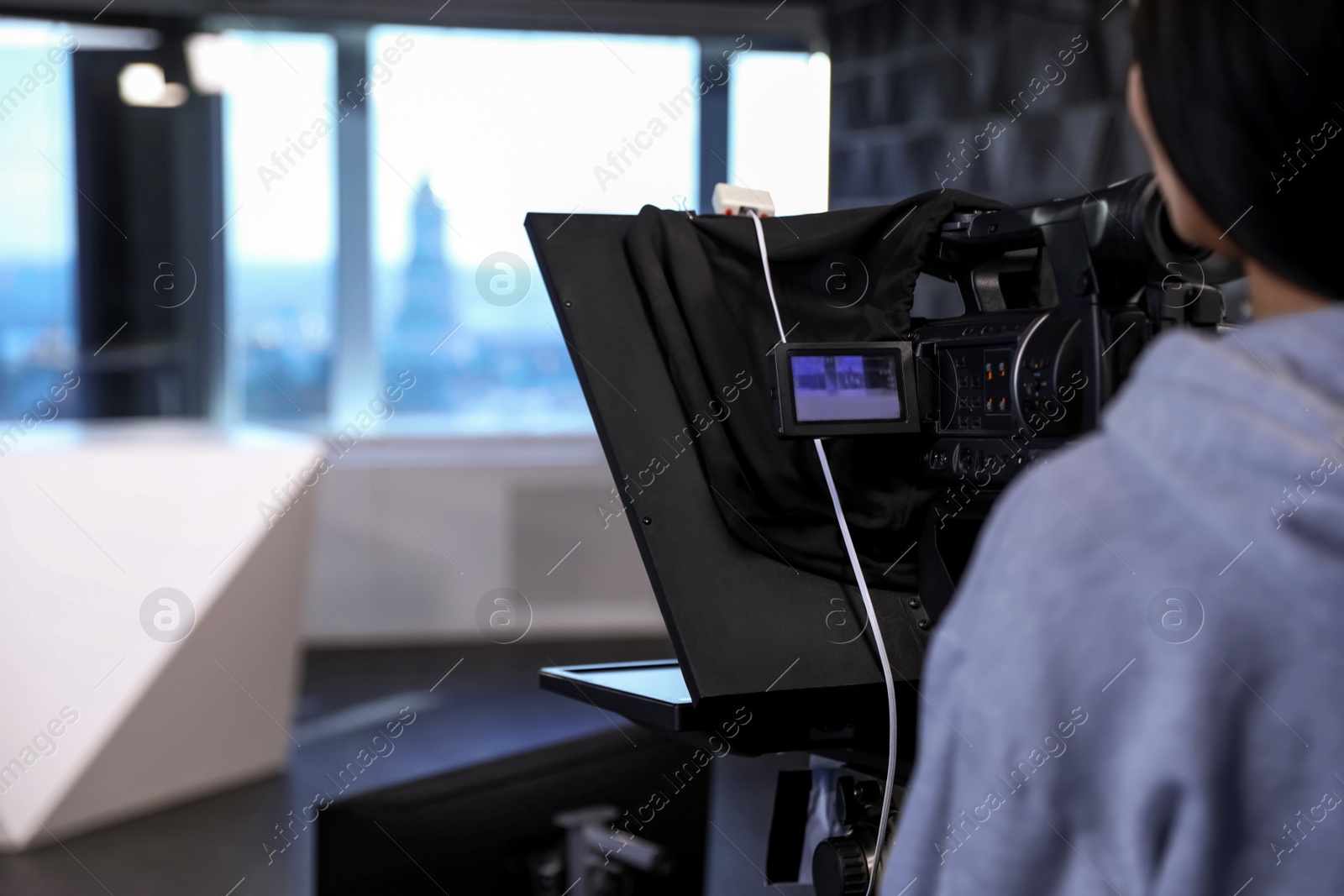 Photo of Professional video camera operator working in studio, closeup