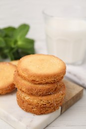 Photo of Tasty sweet sugar cookies on white wooden table, closeup