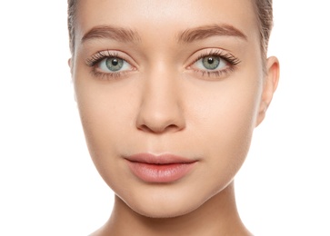 Portrait of young woman with foundation on her face against white background