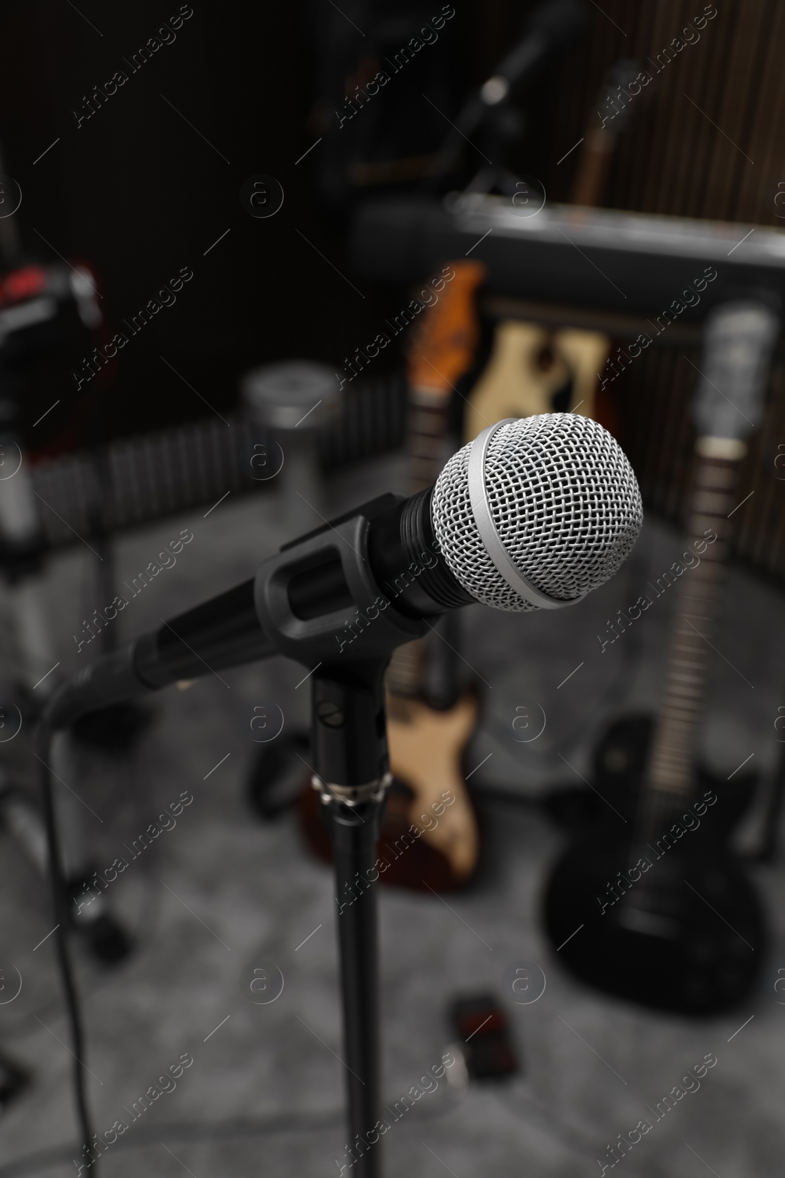 Photo of Modern microphone at recording studio. Music band practice