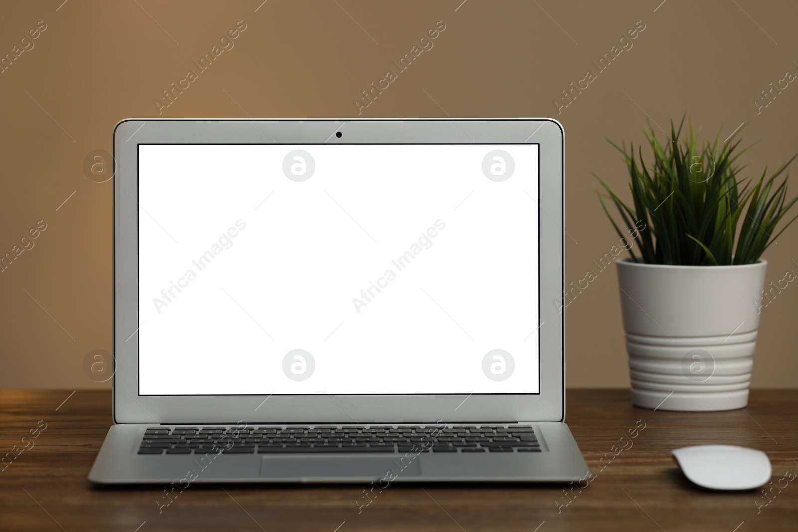 Photo of Laptop with blank screen on table indoors. Space for text