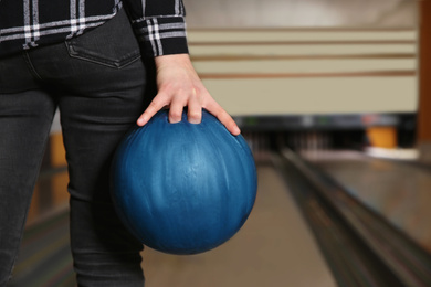 Photo of Woman with ball in bowling club, closeup. Space for text
