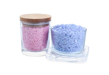 Glass containers of different sea salt isolated on white