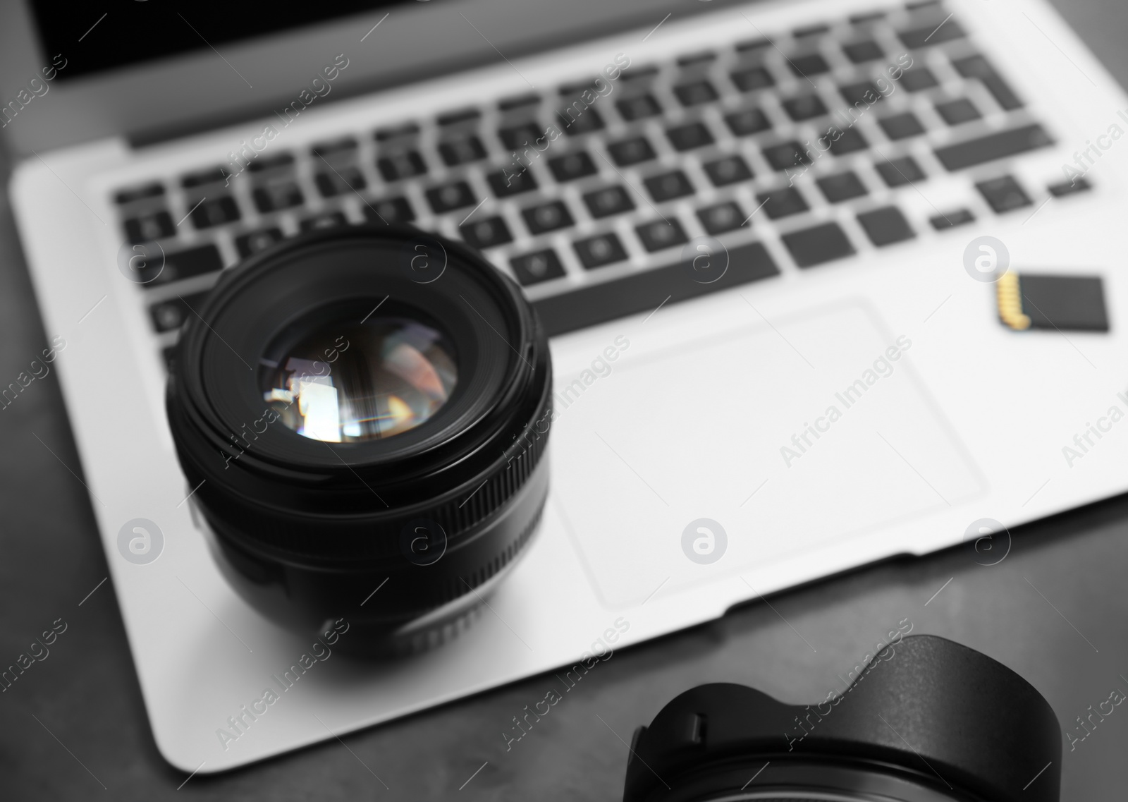 Photo of Professional photographer equipment and laptop on table