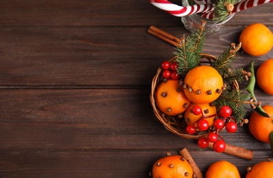 Flat lay composition with tangerine pomander balls on wooden table. Space for text