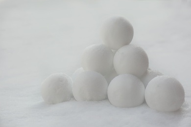 Photo of Pyramid of perfect snowballs on snow outdoors, closeup