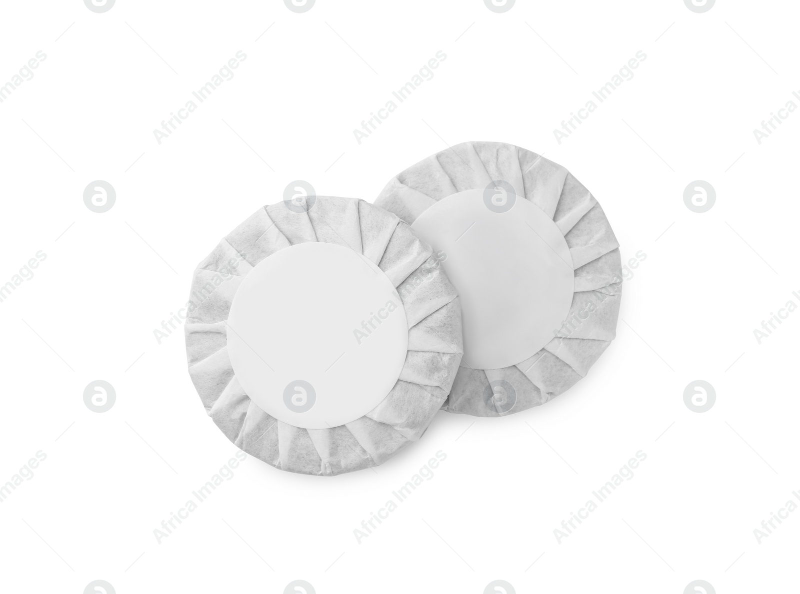 Photo of Disc shaped traditional Chinese pu-erh tea in paper wrap isolated on white, top view