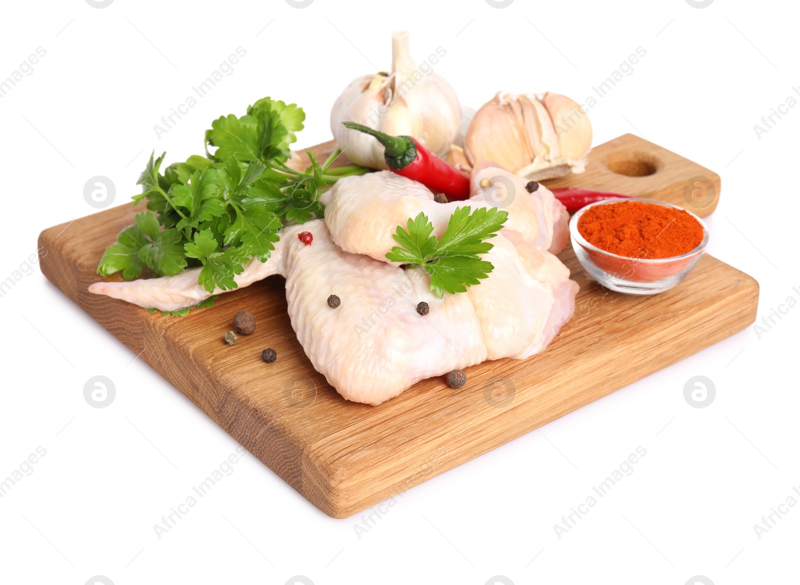 Photo of Raw chicken wings with spices and parsley on white background