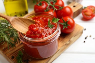 Photo of Eating homemade tomato sauce at white table, closeup