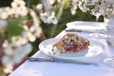 Photo of Stylish table setting with beautiful spring flowers in garden