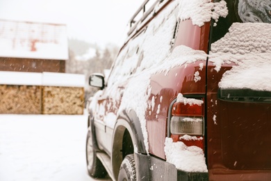 Car covered with snow after storm outdoors on beautiful winter day, closeup