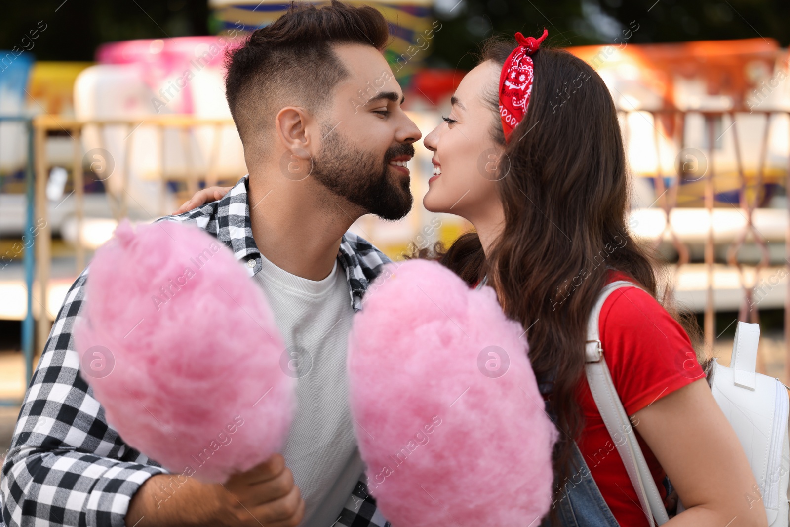 Photo of Happy couple with cotton candies at funfair