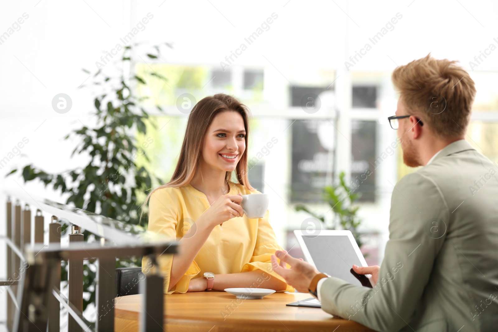 Photo of Insurance agent consulting young woman in office