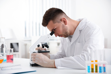 Scientist using modern microscope at table. Medical research