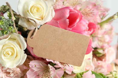 Photo of Happy Mother's Day. Beautiful flowers with blank card on light background, closeup