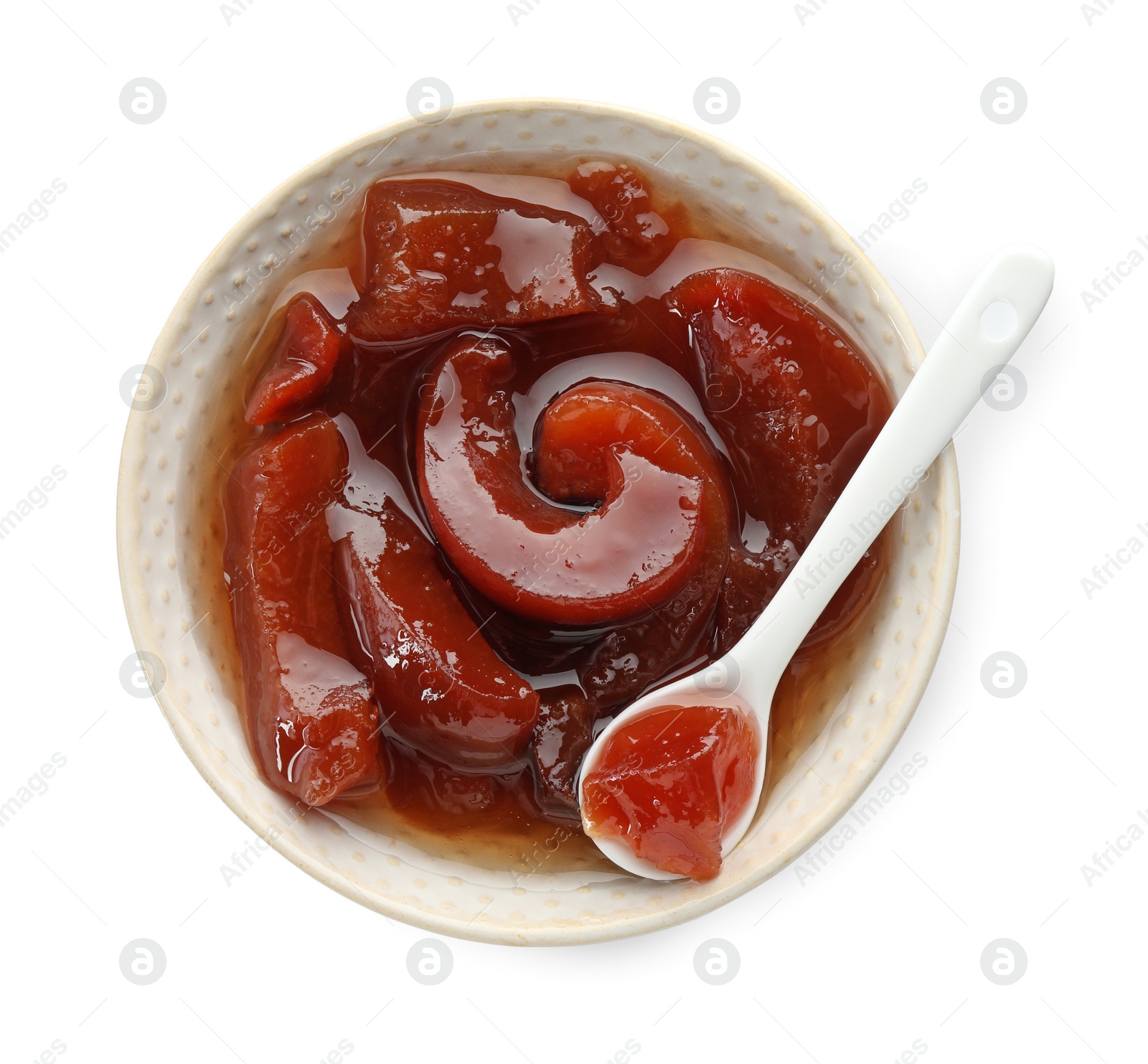 Photo of Tasty homemade quince jam in bowl and spoon isolated on white, top view