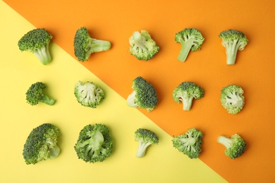 Photo of Flat lay composition with fresh green broccoli on color background