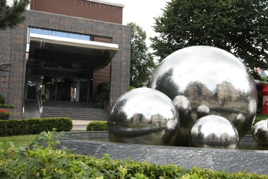 Photo of Truskavets, Ukraine - July 22, 2023: Beautiful fountain near hotel on city street, space for text