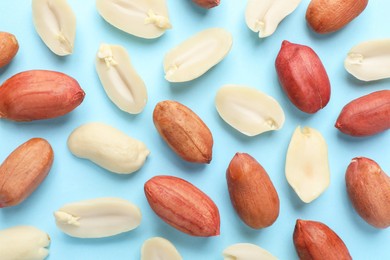 Fresh peanuts on light blue background, flat lay