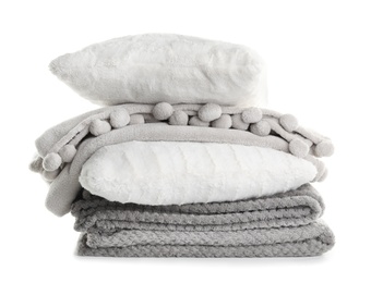 Photo of Stylish soft pillows and folded plaids on white background