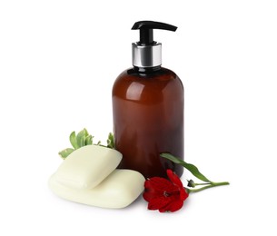 Photo of Soap bars, dispenser and red flower on white background