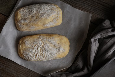 Photo of Raw dough for ciabatta and flour on wooden table, flat lay