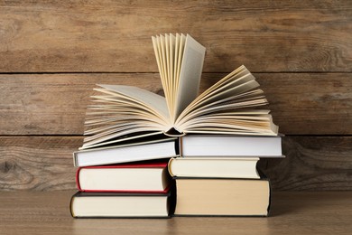 Stack of hardcover books on wooden table