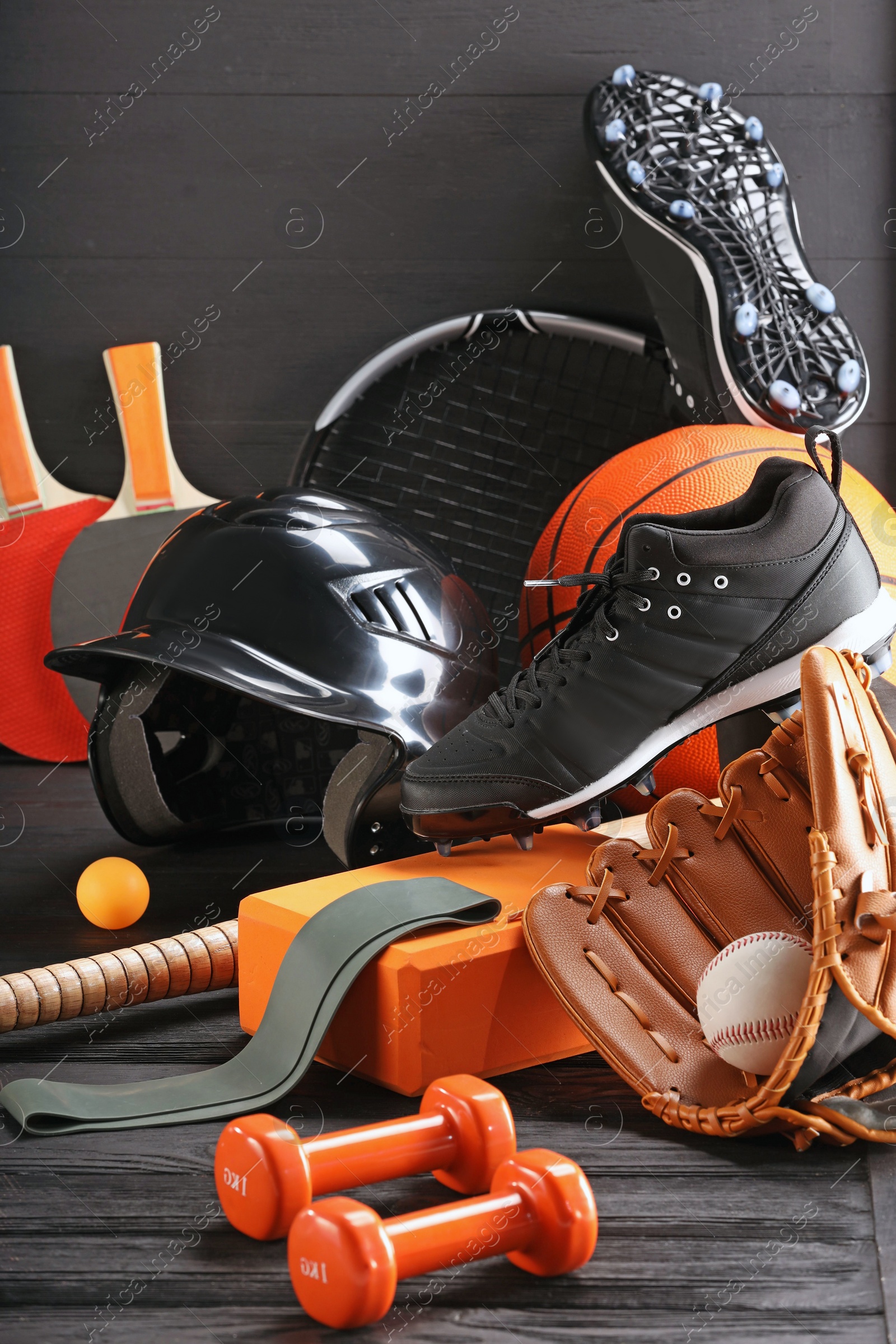 Photo of Many different sports equipment on dark grey wooden table