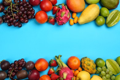 Photo of Assortment of fresh exotic fruits on light blue background, flat lay. Space for text