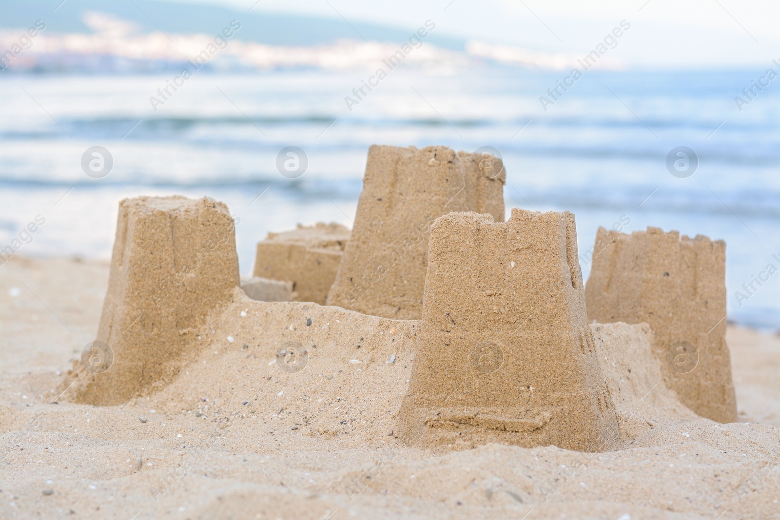 Photo of Beautiful sand castle on beach near sea