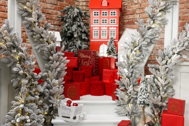 Christmas tree, gift boxes and festive decor indoors. Interior design