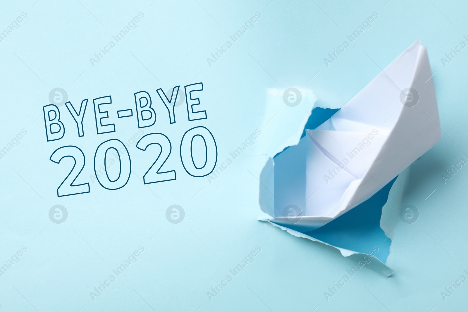 Photo of Bye-bye 2020. Torn paper with toy ship imitating sinking and ending of year