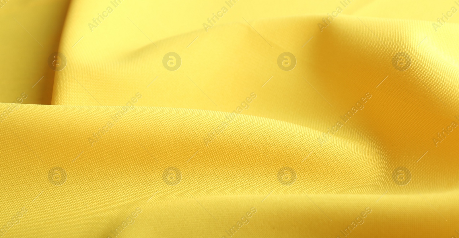 Photo of Texture of beautiful yellow fabric as background, closeup